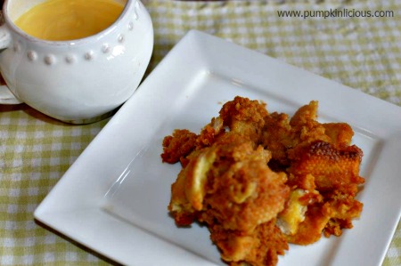 plate of pumpkin bread pudding with jug of cream