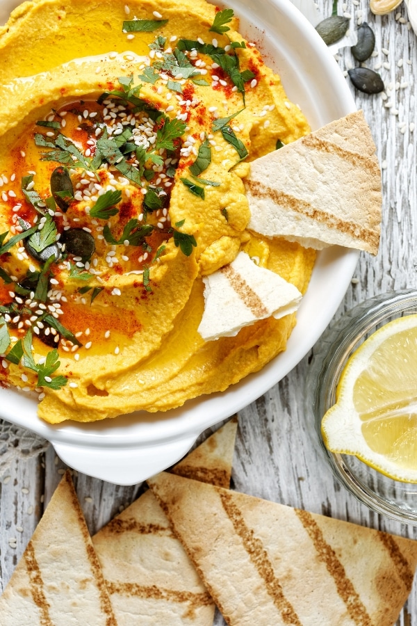 Pumpkin hummus dip is delicious, yet very easy to make. Impress your guests this Thanksgiving with this unique appetizer. Cream cheese mixes perfectly with chili and garbanzo beans to make a flavorful dip for any occasion. #veggiedip #fallrecipes #partyrecipes #Thanksgiving #christmasrecipes #christmasappetizers