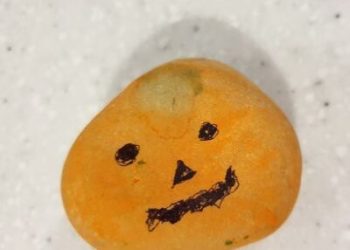 pumpkin face on rock