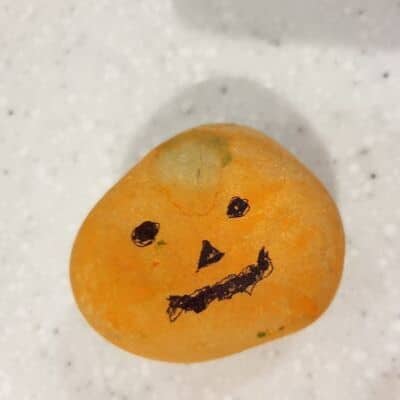 pumpkin face on rock